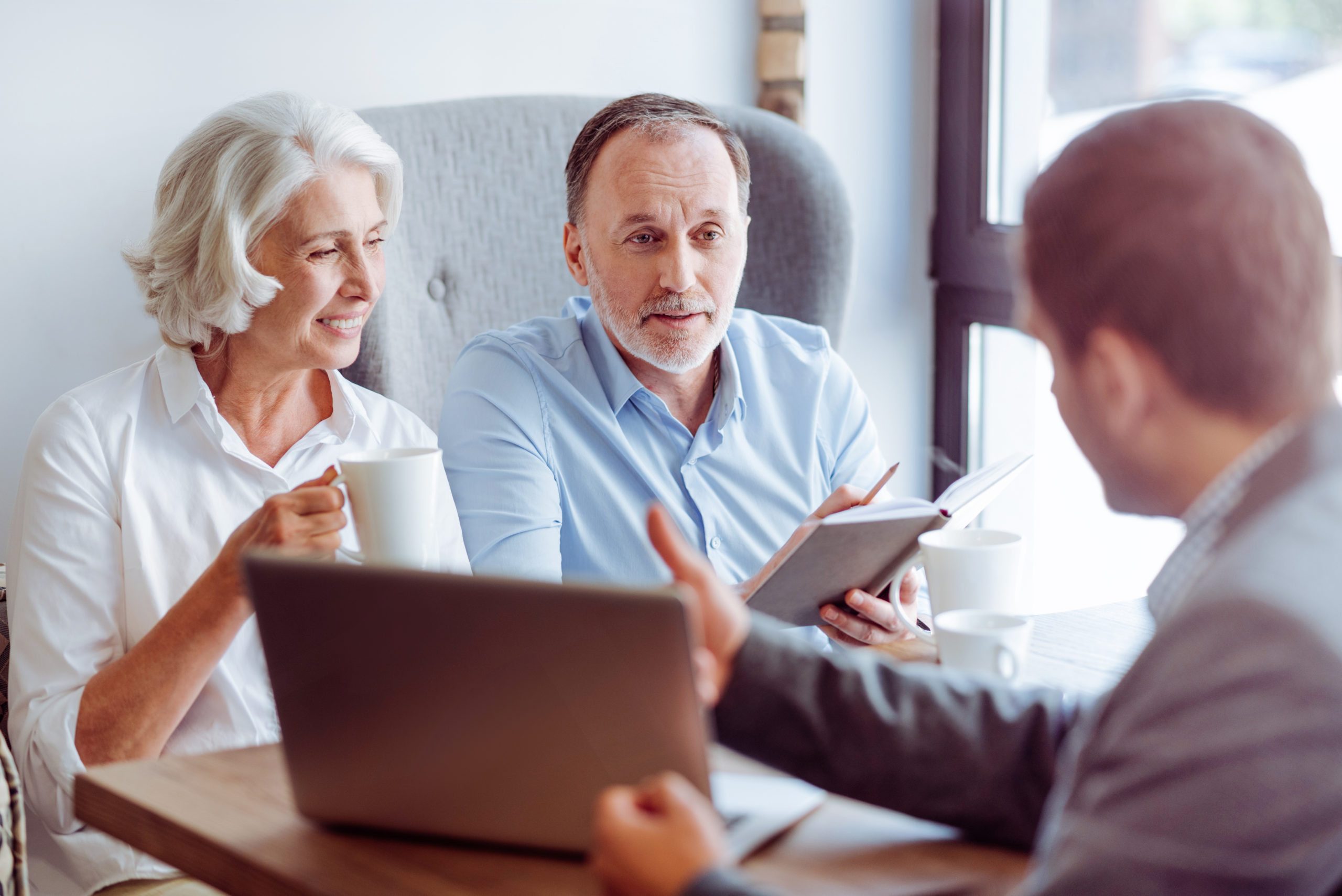 There are different options. Pleasant delighted aged couple sitting in the cafe and meeting with insurance agent while talking